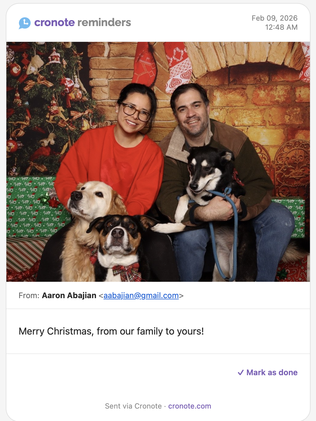 A Cronote reminder with a family Christmas photo and the message: Merry Christmas, from our family to yours!